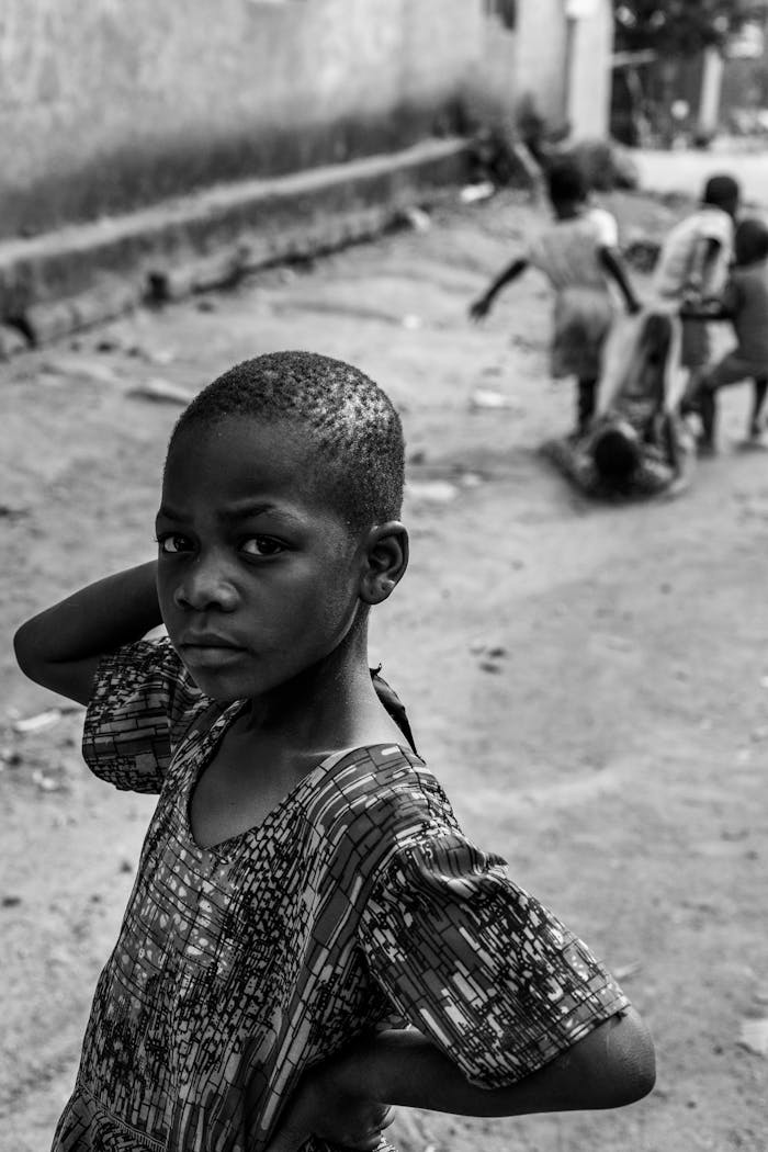 Black and white photo of children playing on a street in Mbeya, Tanzania.